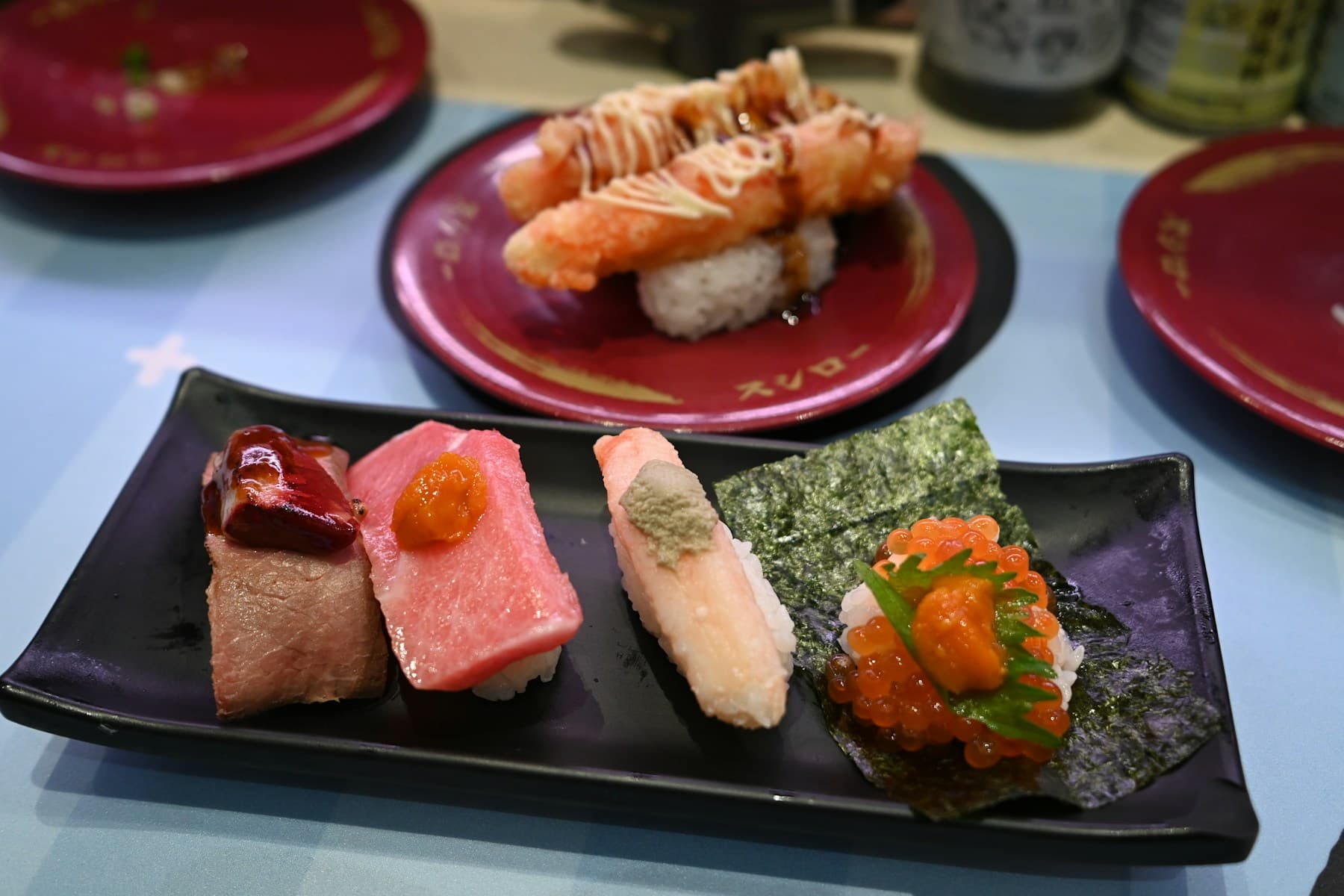 Assorted sushi on a black plate